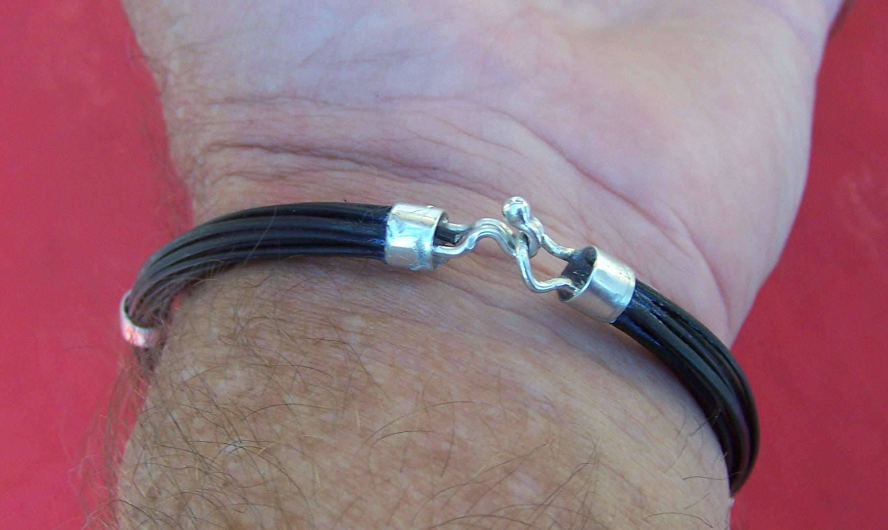 Elephant hair bangle LZK6 displayed on creator Francis Cary's wrist. Lovely on a man or ladies wrist, maybe even a small ankle. - LZK6