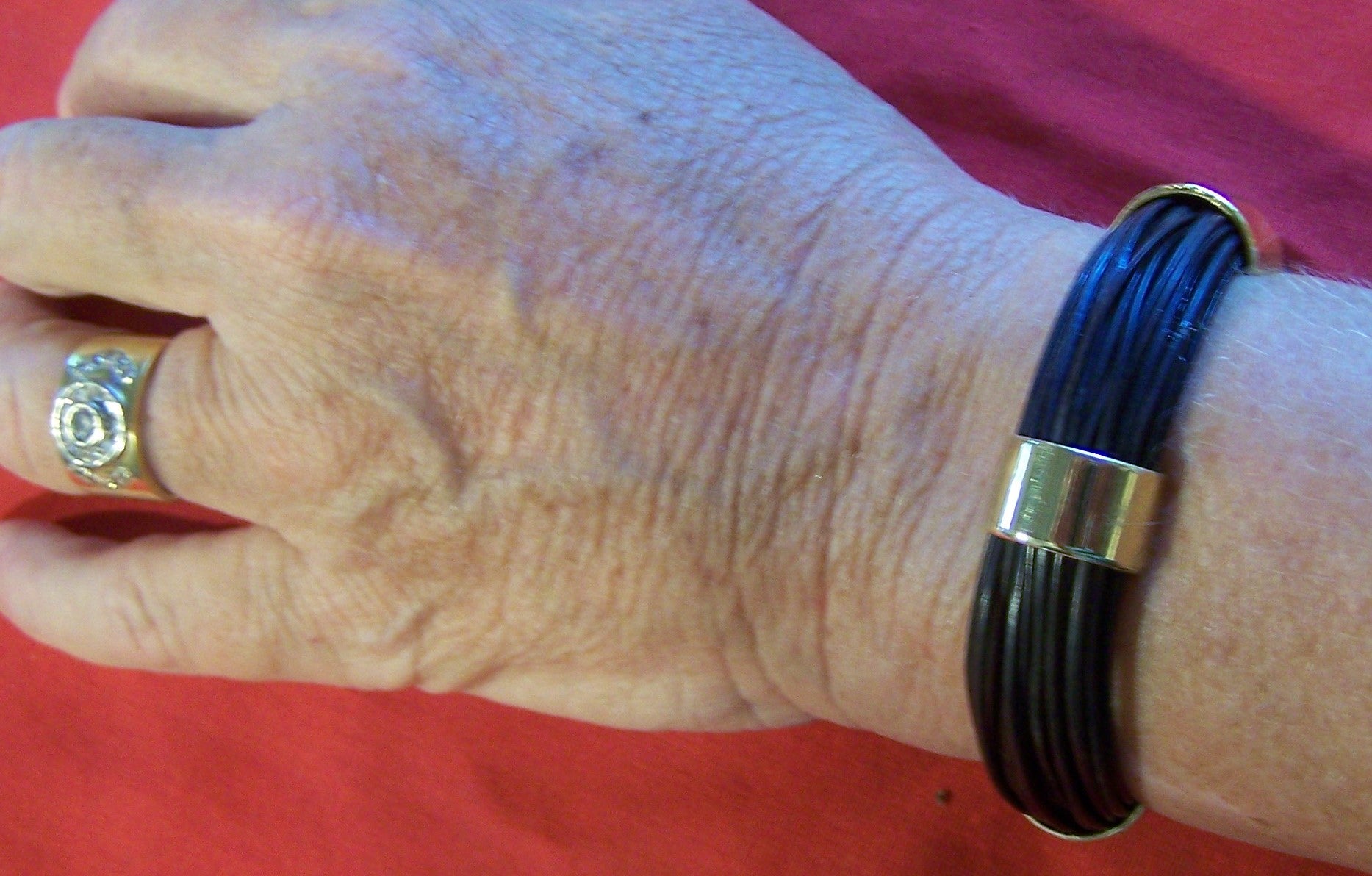 The HBG elephant hair bracelet model on the wrist of the creator's wife. Shown together with gold jewellery which fits nicely.