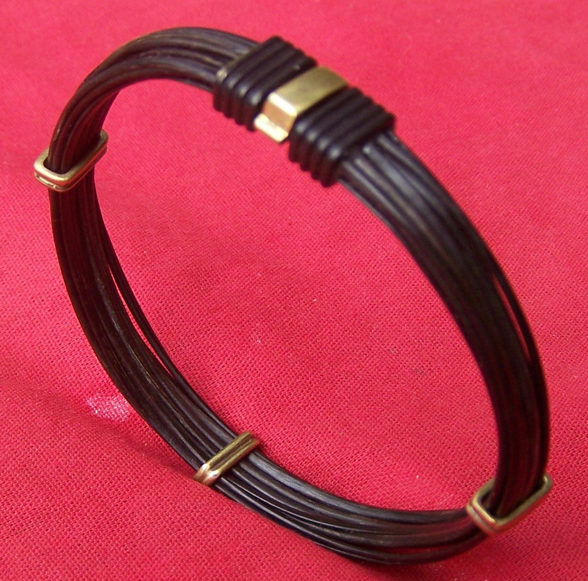 Multiple dark strands of lucky elephant hair secured nicely with brass bracelet sliders and a brass on black clasp. - JE9V