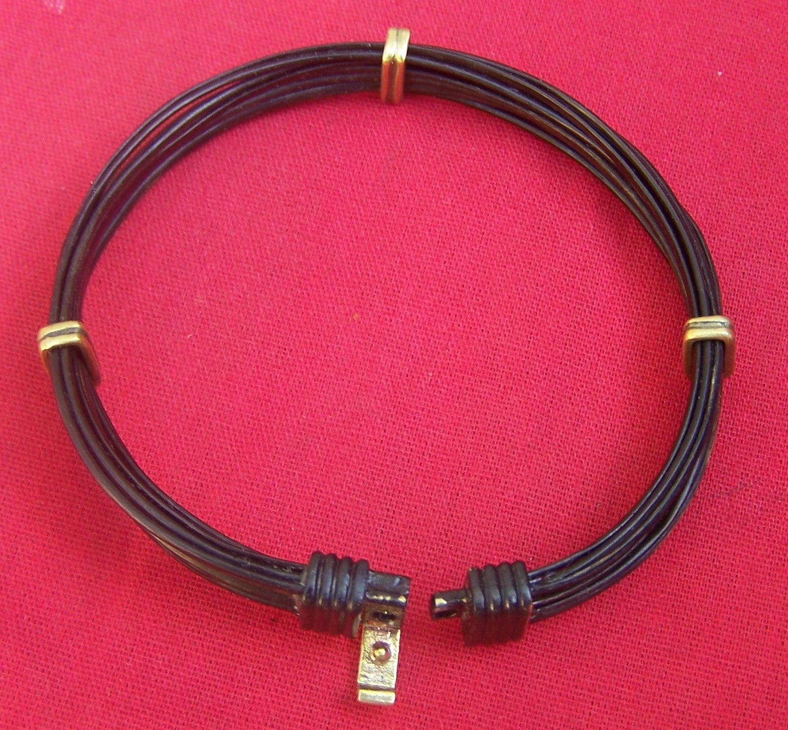 This brass on black clasp clicks to close and secure the JE9V elephant hair bracelet to your wrist.