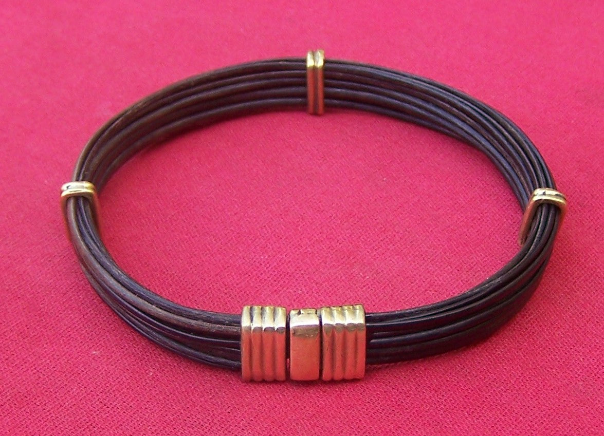 Multiple dark strands of lucky elephant hair secured nicely with brass bracelet sliders and a brass clasp. - JEJX