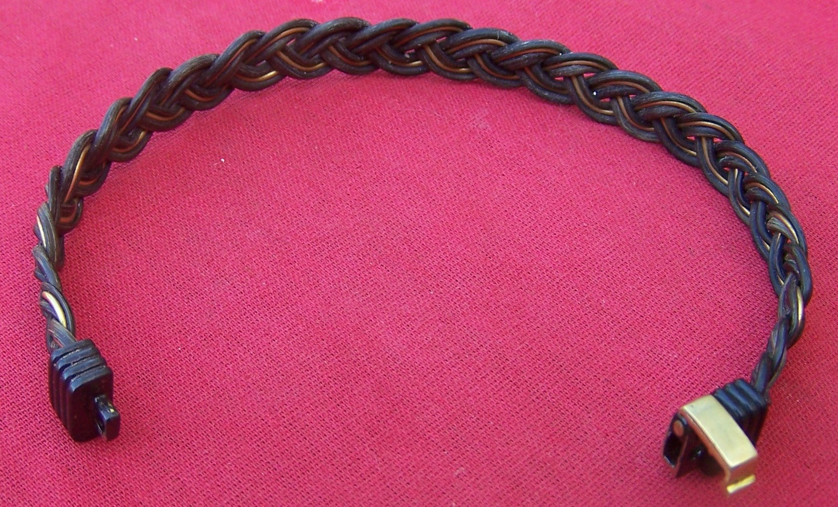 The brass on black clasp clicks to close and secure the JELB's combination of the lovely dark elephant hair and the brass filament weave to your wrist.