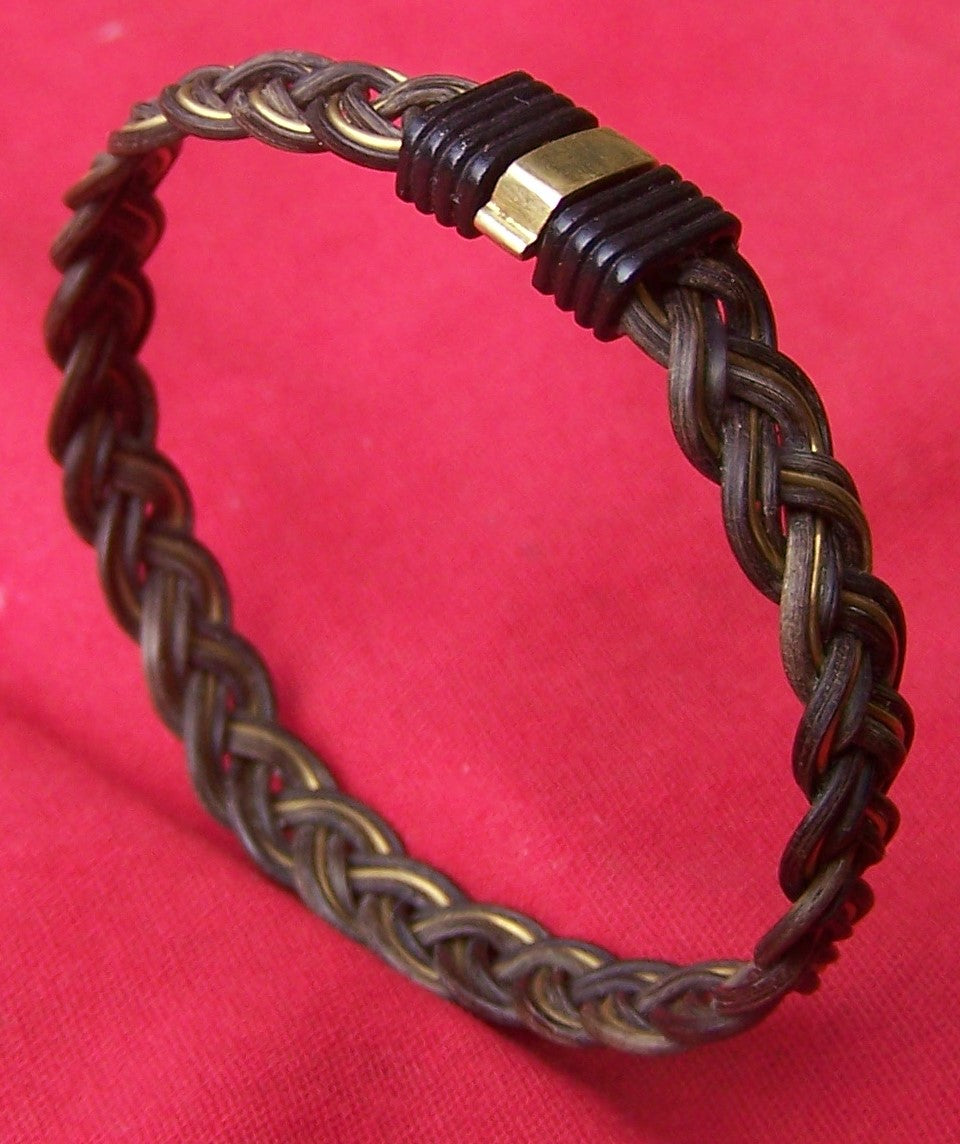 Two parts elephant hair with one part brass wire are woven into this braided marvel. A contrasting brass on black clasp finishes the design nicely. - JELB
