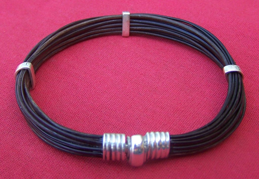 Multiple dark strands of lucky elephant hair secured nicely with sterling silver bracelet sliders and a sterling silver clasp. - JEZA