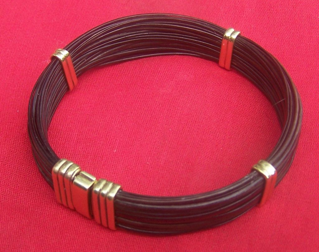 This flat round elephant hair bracelet is secured with brass bands and clasp. This elephant hair bangle is perfect for ladies or men in the market for a lovely wrist or ankle adornment. - JJ86