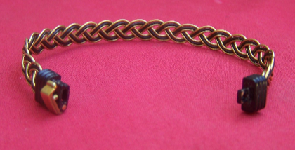 The brass on black clasp of the JE5R clicks to secure your elephant hair bracelet to your wrist.